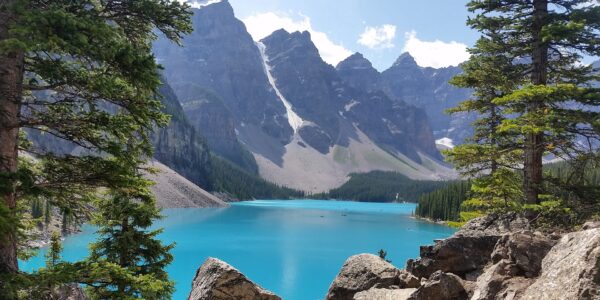 Moraine Lake and Valley of Ten Peaks reflecting in turquoise waters on summer morning