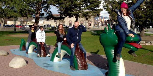 Our passengers sitting on the famous Ogopogo Monster in Kelowna!