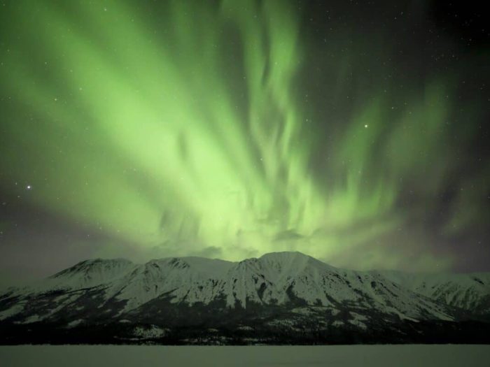 The northern lights flow over Jack Peak and Tutshi Lake along the BC, Yukon border.